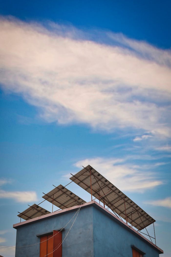 Solar panels mounted on a rooftop against a clear blue sky.